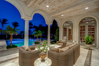 Twilight Covered Loggia with Arched Columns and Pool Views Photography | Jupiter, FL