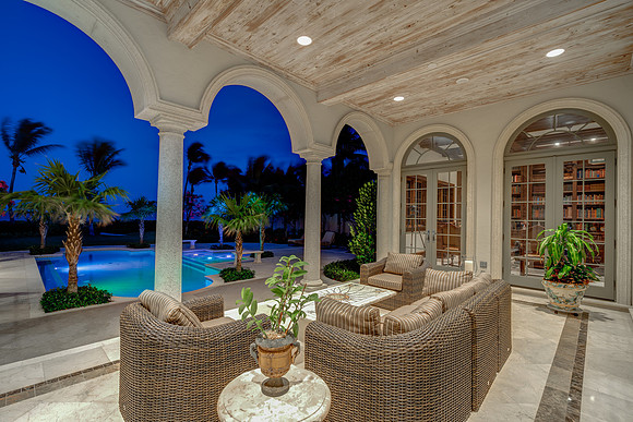 Twilight Covered Loggia with Arched Columns and Pool Views Photography | Jupiter, FL