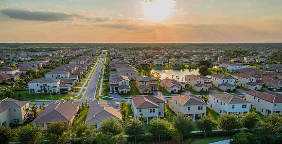 Aerial Twilight View of a Suburban Residential Community with Lakes in South Florida