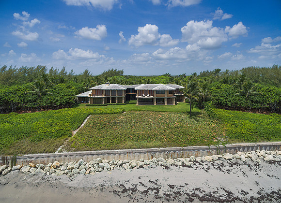Aerial View of a Modern Oceanfront Estate with Seawall in South Florida