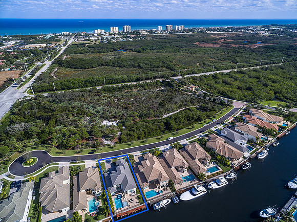 Aerial View of a Waterfront Townhome Community with Boat Docks Near the Coast in South Florida