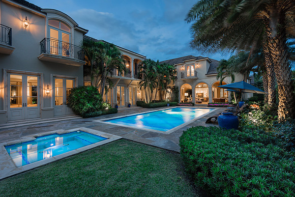 Twilight Estate Rear Exterior with Illuminated Pool Photography | Jupiter, FL
