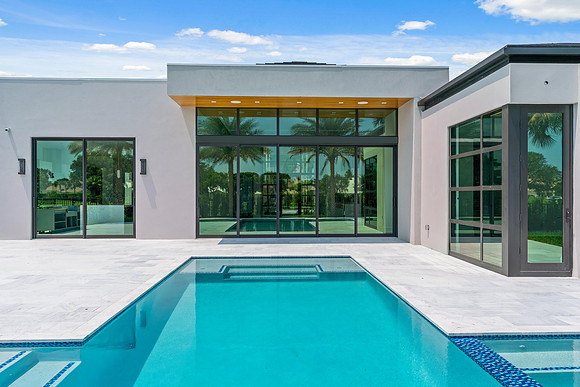 Modern Home Exterior with Glass Walls and Pool Photography | Jupiter, FL