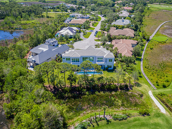 Aerial View of a Luxury Home Surrounded by Nature Preserve and Golf Course in South Florida