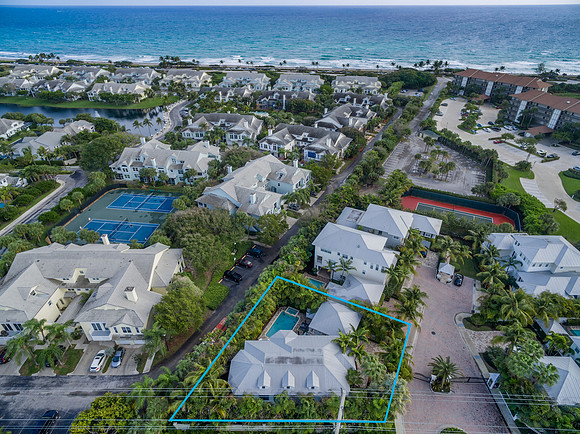 Aerial View of a Beachfront Community with Tennis Courts in South Florida