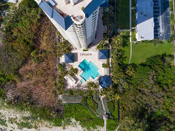 Top-Down Aerial View of a High-Rise Condo Pool Deck in South Florida