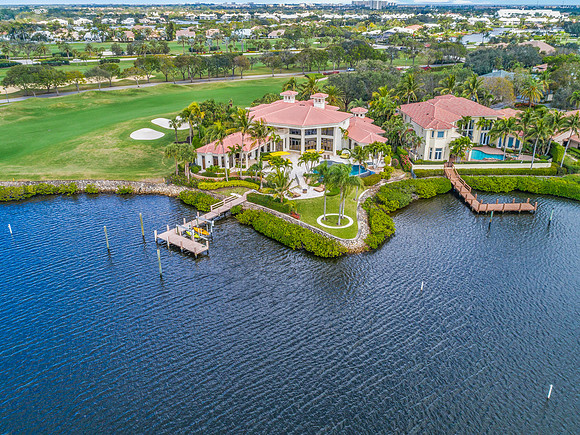 Aerial View of a Waterfront Estate with Boat Docks and Golf Course Views in South Florida