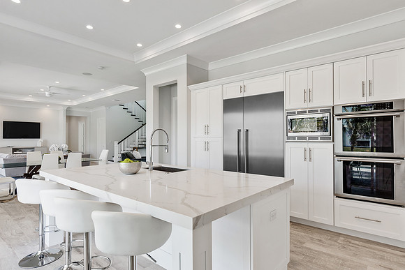 Bright White Kitchen with Waterfall Island and Double Ovens Photography | Jupiter, FL