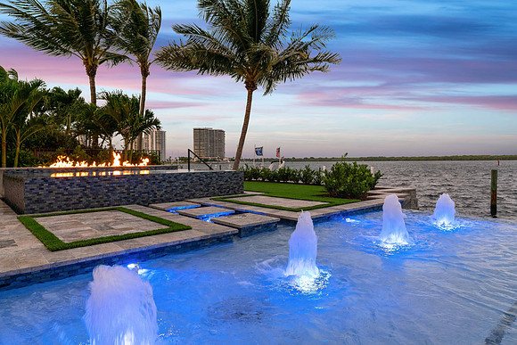 Twilight Waterfront Pool with Fountain Jets and Fire Feature Photography | Jupiter, FL