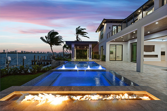 Twilight Waterfront Home Exterior with Pool and Fire Feature Photography | Jupiter, FL