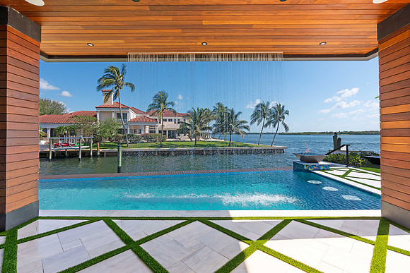 Waterfront Pool Photography Framed by Outdoor Pavilion | Jupiter, FL Real Estate Photographer